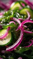 Wakame salad with red onion and cucumber in a vinegar dressing.