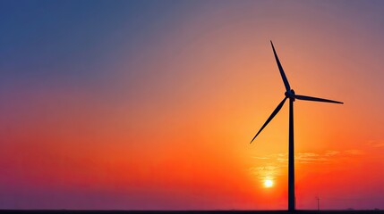 Obraz premium Wind turbine against sunset sky, symbolizing clean energy and sustainable future