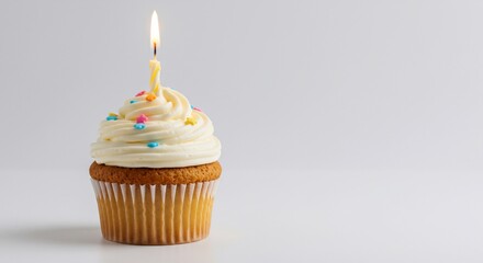Birthday Cupcake with Lit Candle and Sprinkles on White Background