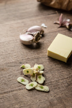 sliced garlic on a wooden board