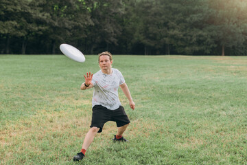 Athletic male with concentrated expression, patterned white shirt, black shorts, smartwatch moves...