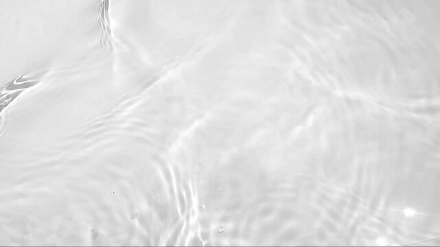 Pure water with reflections sunlight in slow motion. Water surface texture top view. Sun and shadows. Motion clean swimming pool ripples and wave.
