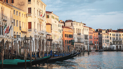 Venice canals at sunset with colorful buildings and gondolas at the dock
