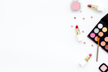 Flatlay of makeup cosmetics on white background. Blusher, mascara and lipstick, top view