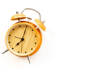 Vintage wooden alarm clock with bells at seven o'clock. Morning routine. In time concept