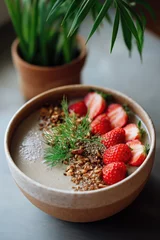  Creamy smoothie bowl with strawberries, granola, and fresh dill garnish © Iryna