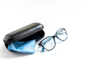 Stylish eyeglasses with glasses case on white. Eye care and protection concept