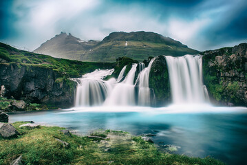 View to the Kirkjufell waterfall at summer. Kirkjufellsfoss waterfall, Iceland, Europe.