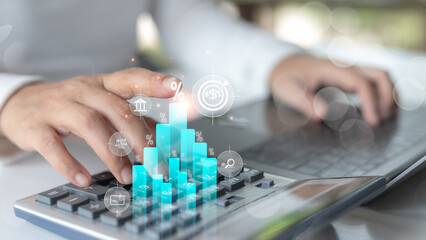 Hand calculating financial data on a calculator with digital graph, finance icons, investment...