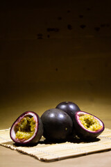 Fresh Passion Fruits Displayed On A Bamboo Table Mat in Soft Lighting