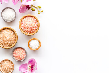 Spa composition with many different kinds of sea salt in bowls, top view