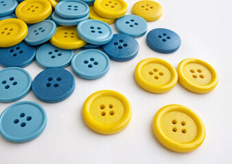 Fototapeta premium yellow and blue buttons on a white background