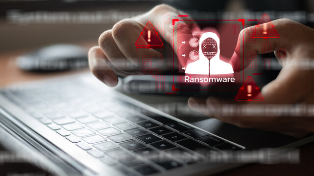 Hands holding a smartphone with a ransomware warning and a hacker alert, representing a cybersecurity cyberattack and data protection threat, a digital crime concept. - Powered by Adobe