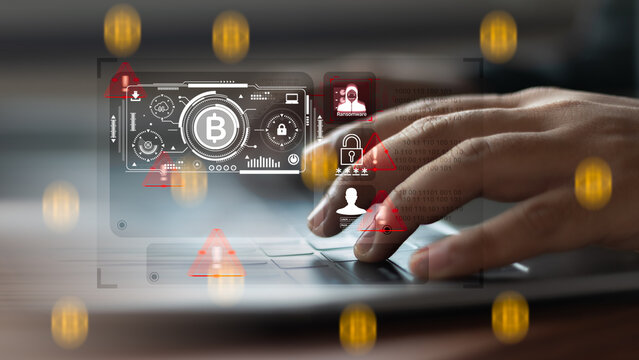 Hands typing on laptop keyboard with ransomware alert, bitcoin payment interface, and cybersecurity threat, concept of digital crime and cryptocurrency attack.