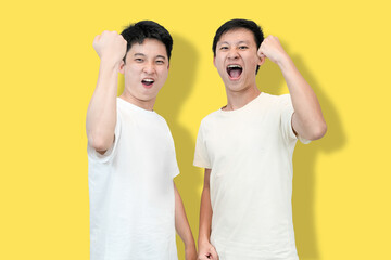 Two young Asian men face each other with clenched fists and open mouths