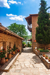Peaceful monastery stone courtyard with flower pots in Meteora Greece