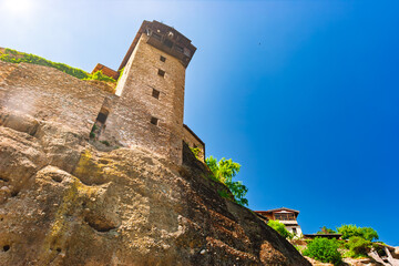 Meteora monastery tower built on dramatic cliffs under clear blue sky