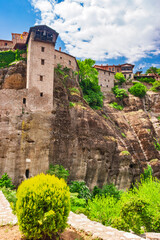 Ancient stone monastery complex built on dramatic vertical cliffs in Meteora Greece