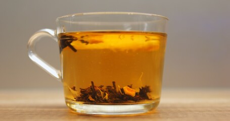 Hot water in transparent glass mug brings out bold flavors of herbal tea with lemon slice. Aromatic beverage with sour fruit offers delicate taste cooling down