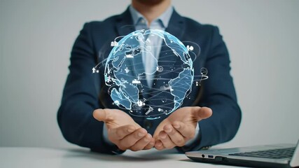 Businessman Holding a Holographic Globe with Data Connections in a Blue Suit Jacket with Clean Background Using a Laptop in White Table - Powered by Adobe