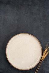 Empty Ceramic Plate on Rustic Stone Table. Minimalist Dining Concept	