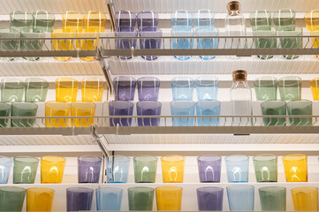 Colorful glasses and bottles arranged on shelves in a pantry setting