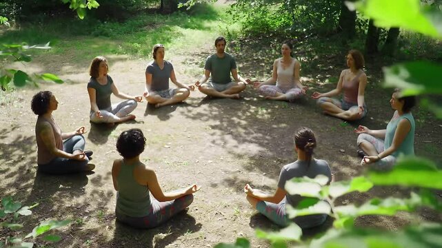 A group of people practices mindful meditation in a circle in a peaceful natural setting