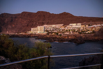 Silhouette of a mountain on the horizon at sunset on the Atlantic Ocean coast near Tenerife island	

