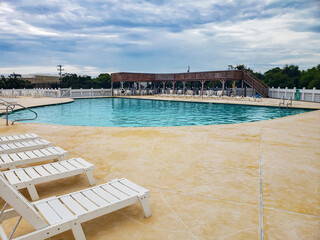 Peaceful Poolside with Sunbeds and Patio