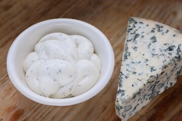 Creamy Dorblu Sauce and Cheese Wedge on Wooden Board as an Aesthetic Accent for Gourmet Recipes and Premium Food Content