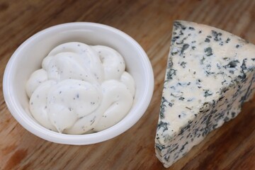 Creamy Dorblu Sauce and Cheese Wedge on Wooden Board as an Aesthetic Accent for Gourmet Recipes and Premium Food Content