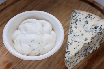 Creamy Dorblu Sauce and Cheese Wedge on Wooden Board as an Aesthetic Accent for Gourmet Recipes and Premium Food Content