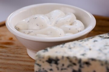 Creamy Dorblu Sauce and Cheese Wedge on Wooden Board as an Aesthetic Accent for Gourmet Recipes and Premium Food Content