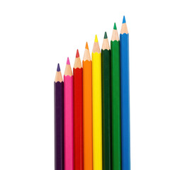 Fototapeta premium A rainbow spectrum of sharpened colored pencils arranged in ascending order isolated on transparent background