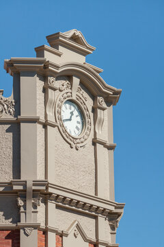 A clock face on the corner of a building facade