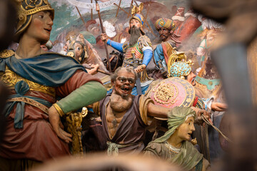 Colorful Sculpture Depicting a Medieval Battle Scene With Multiple Figures