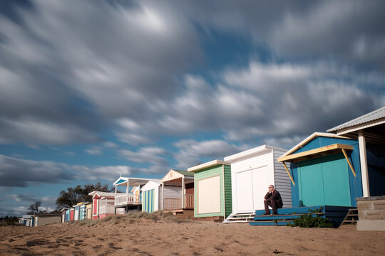 Man seated on Steps of Bathing Box, Mount Martha Beach