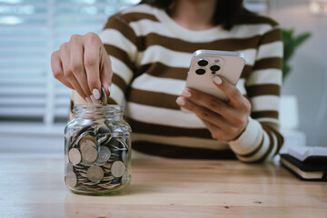 A woman holds a piggy bank, which symbolizes savings, financial planning, and economic challenges....