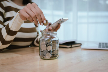 A woman holds a piggy bank, which symbolizes savings, financial planning, and economic challenges....