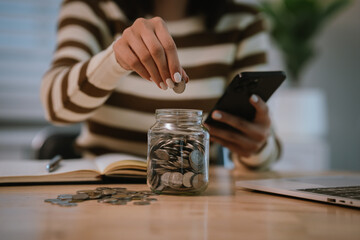 A woman holds a piggy bank, which symbolizes savings, financial planning, and economic challenges....