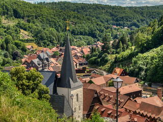 Panoramic view of Stolberg in Saxony-Anhalt, Germany. A church spire rises above red half-timbered...