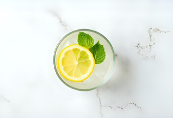 Flat lay of glass filled with lemon slices, mint leaves, and cold water, placed on white marble background. Minimalist summer drink concept with clarity and freshness.