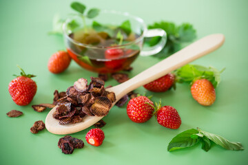 Strawberry fruit tea in a glass teapot from above