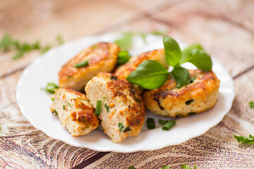 dinner of chicken cutlets with herbs, on a wooden table
