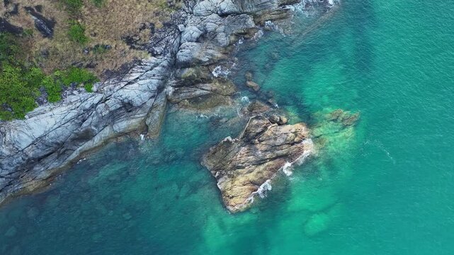 Top down aerial view from above of big waves crashing and foaming on rock stones,Amazing seashore nature background,Wide angle view ocean sea from drone camera 4k High quality footage ProRes 422