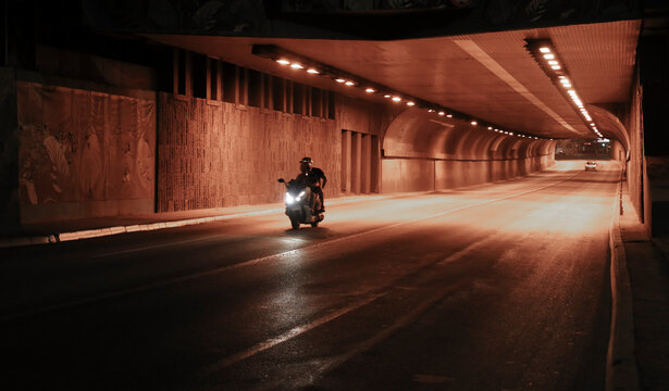 Night traffic BELGRADE, SERBIA cars passing with speed blur in Terazije Tunnel, or Terazijski Tunel, by Zeleni Venac in Stari Grad center of the city, the central spot Couple ride on moped motorcycle