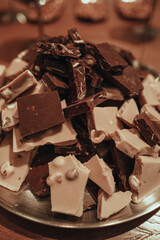 Close up detail white and dark broken chocolate pieces, delicious and sweet dessert