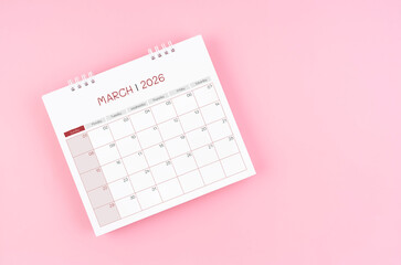 March desk calendar for 2026 year on pink background for schedule to make appointment meeting.