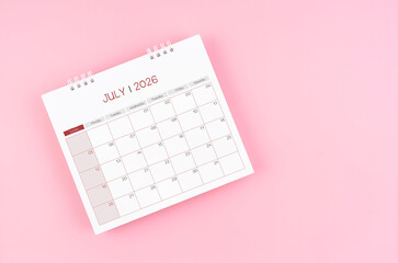 July desk calendar for 2026 year on pink background for schedule to make appointment meeting.
