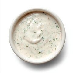 top down shot of a small dip cup ranch sauce. isolated against white background